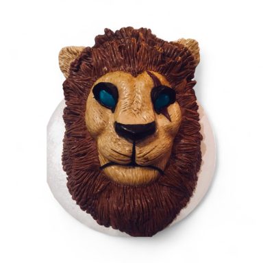 Lion head sculpture with detailed fur and blue eyes.