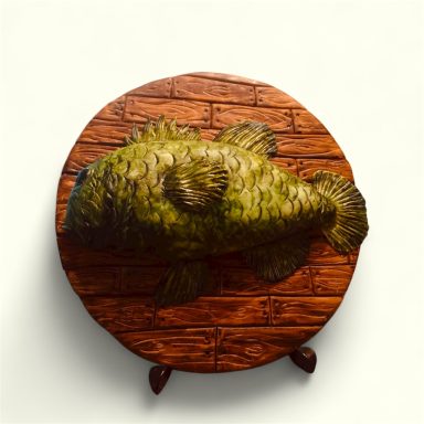 A round table with a fish design on a wooden surface.